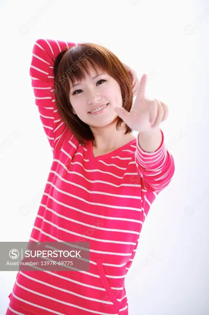 Young woman looking at the camera and touching with smile