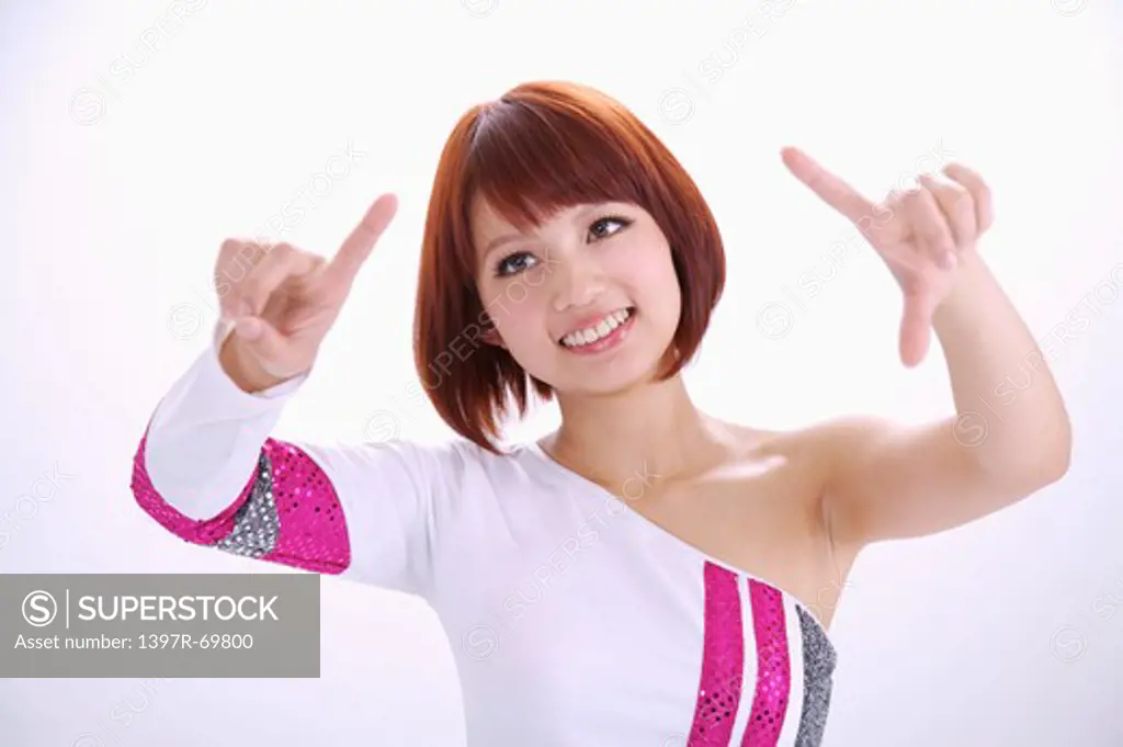 Young woman looking away and touching screen with smile