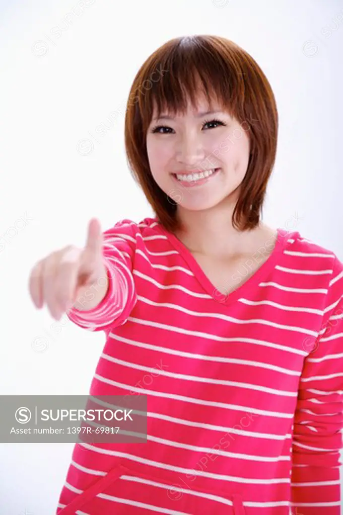 Young woman looking at the camera and touching screen with smile