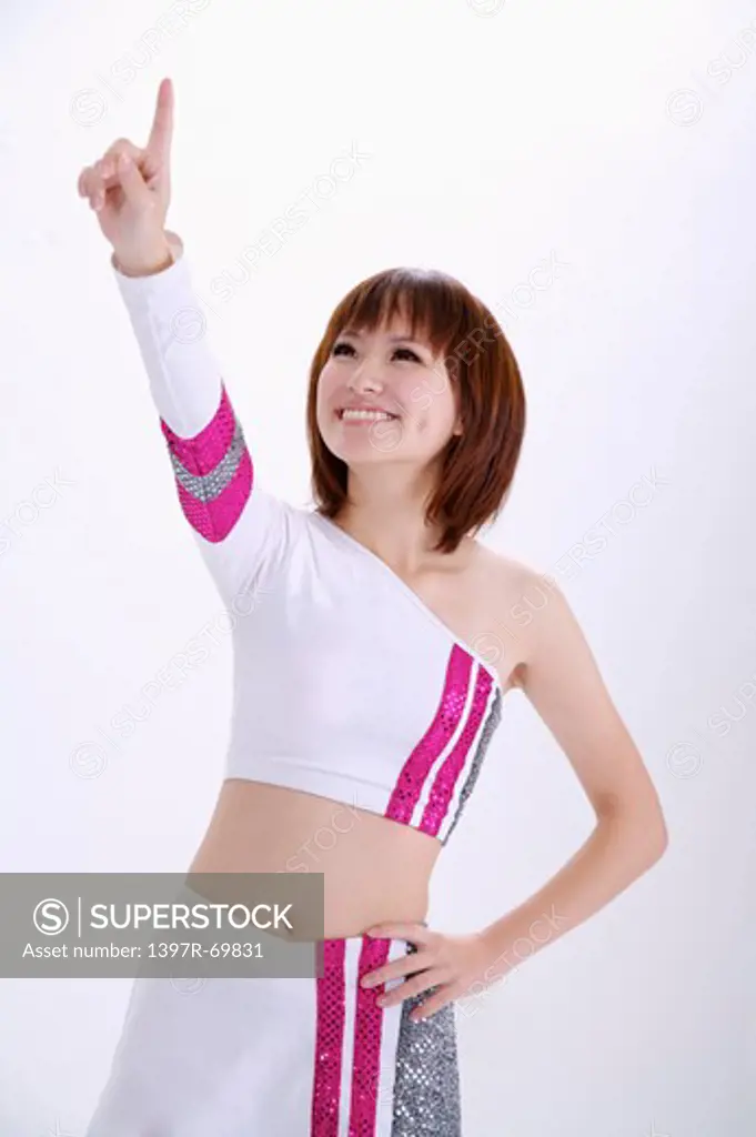 Young woman looking up and touching screen with smile