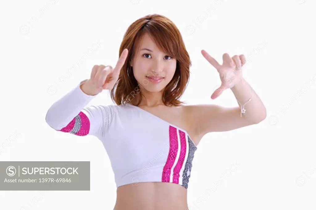 Young woman looking at the camera and making gesture of touching