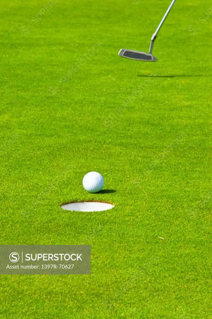 Close-up of golf ball and golf swing on the green lawn
