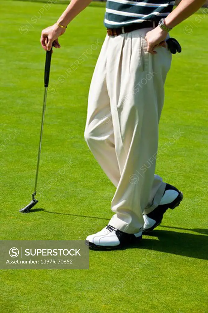 Man standing on the lawn with a golf swing