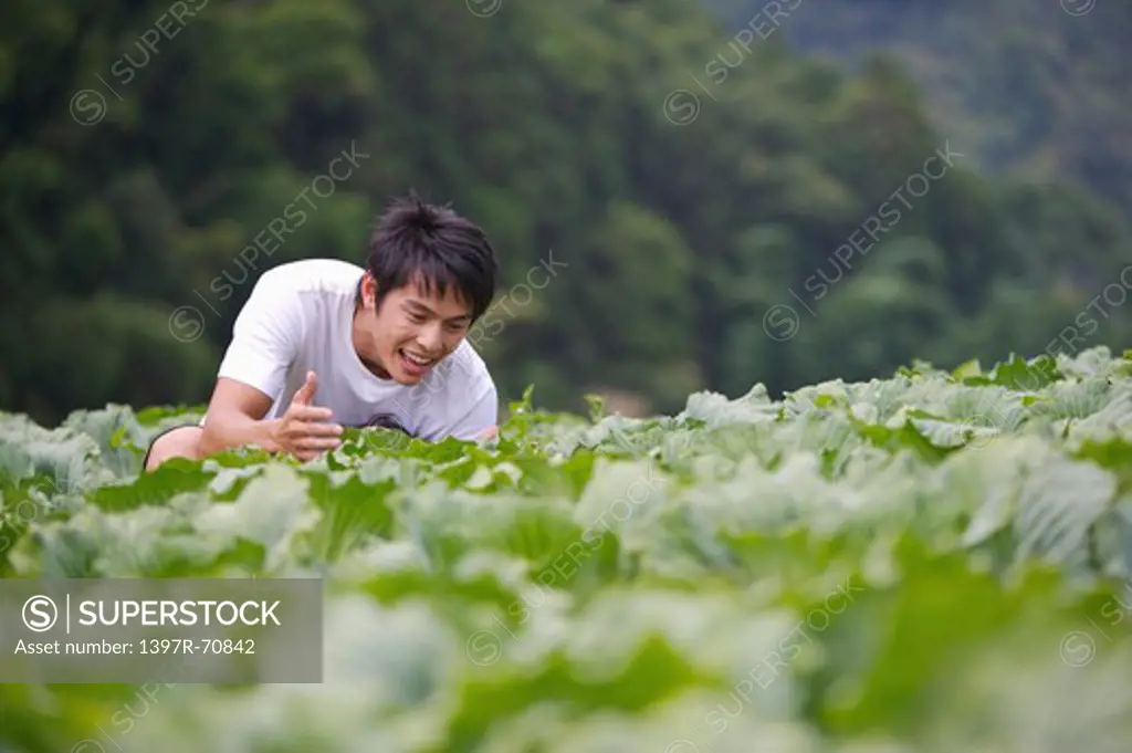 Young man laughing in the vegetable garden
