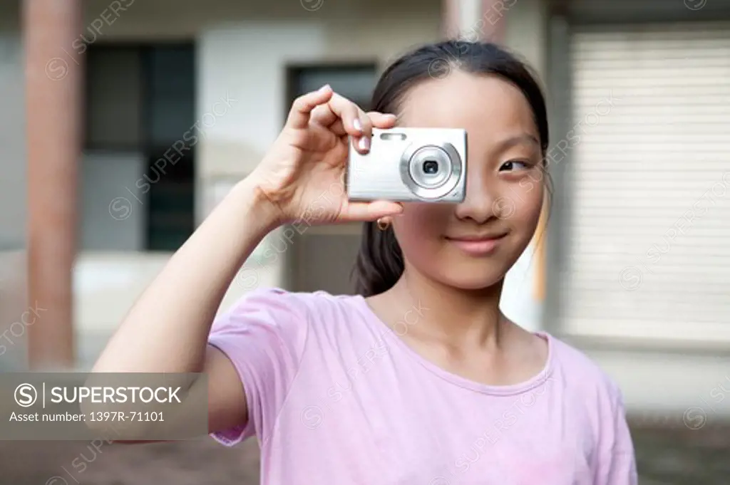 Girl taking pictures with digital camera