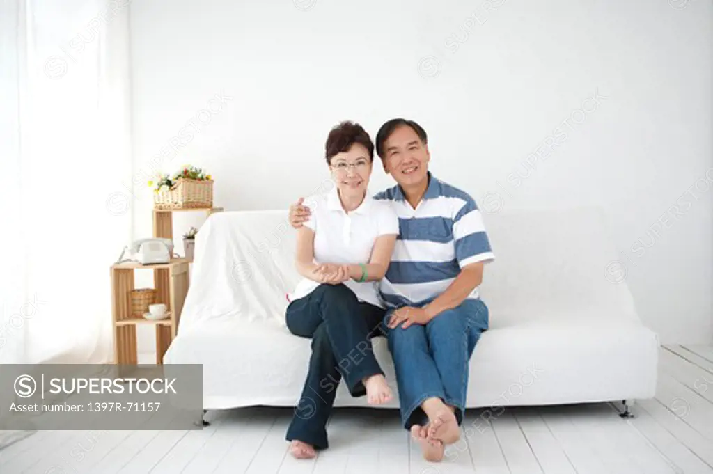 Portrait of a Senior couple sitting in living room