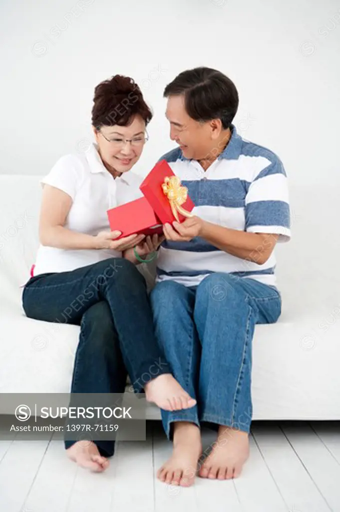 Senior man giving wife a present