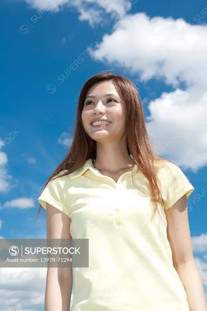 Young woman looking away and smiling happily