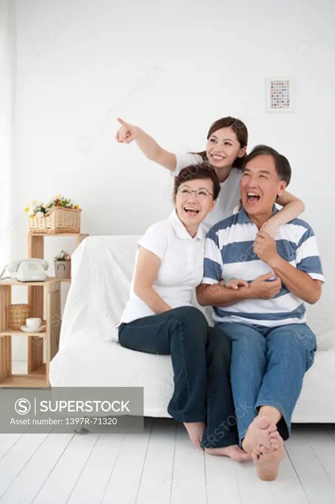 Family with one child looking away and smiling happily together