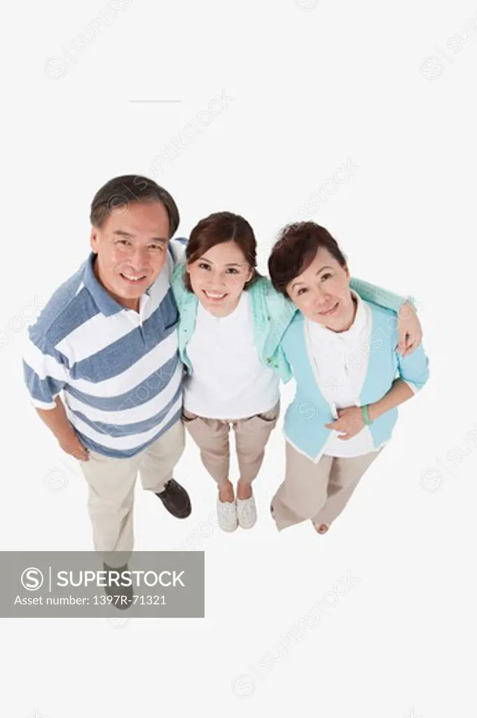 Family with one child standing together and looking up with smile
