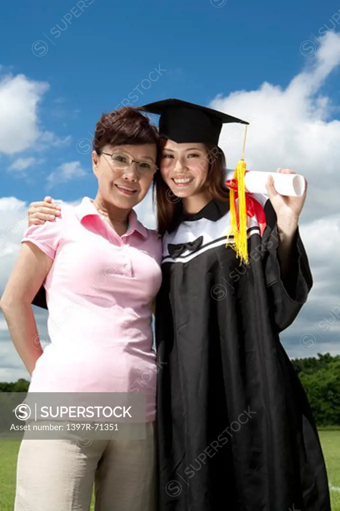 Mother and daughter standing and smiling together on graduation