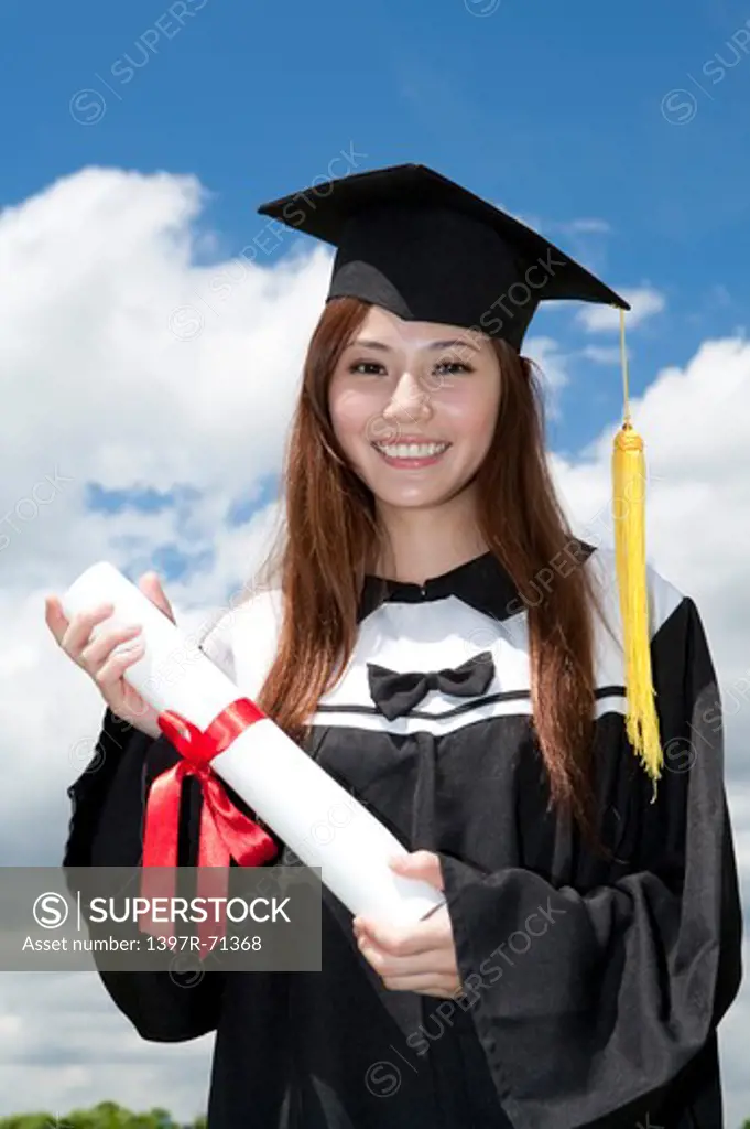 Young woman holding diploma and smiling