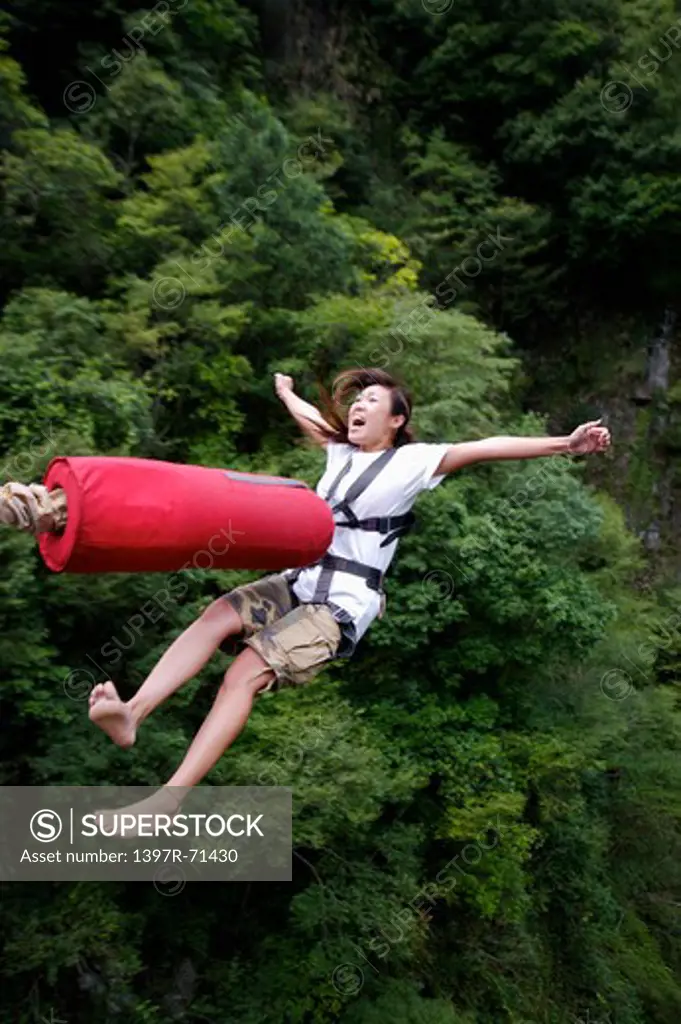 Woman bungee jumping, shouting