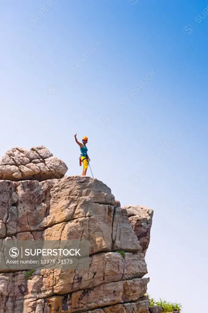 Rock climber standing on mountain peak
