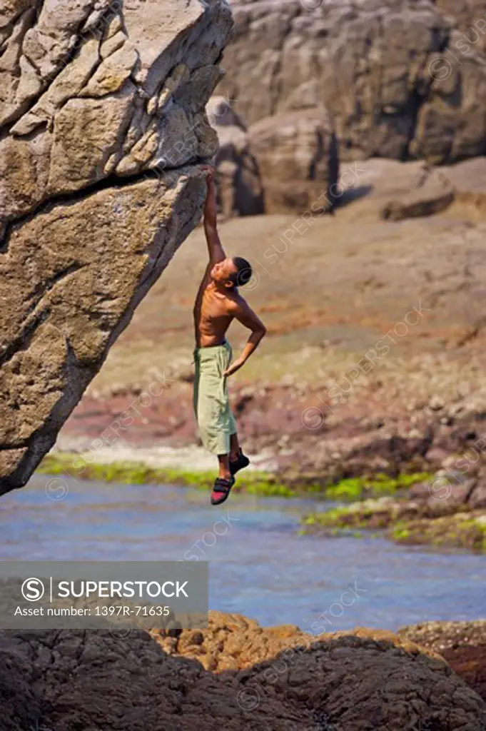 Mature man climbing on the cliff in mid-air, Rock Climbing, Extreme Sports