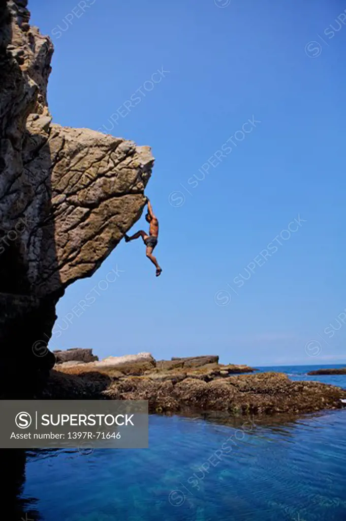 Mature man climbing on the cliff, Rock Climbing, Extreme Sports