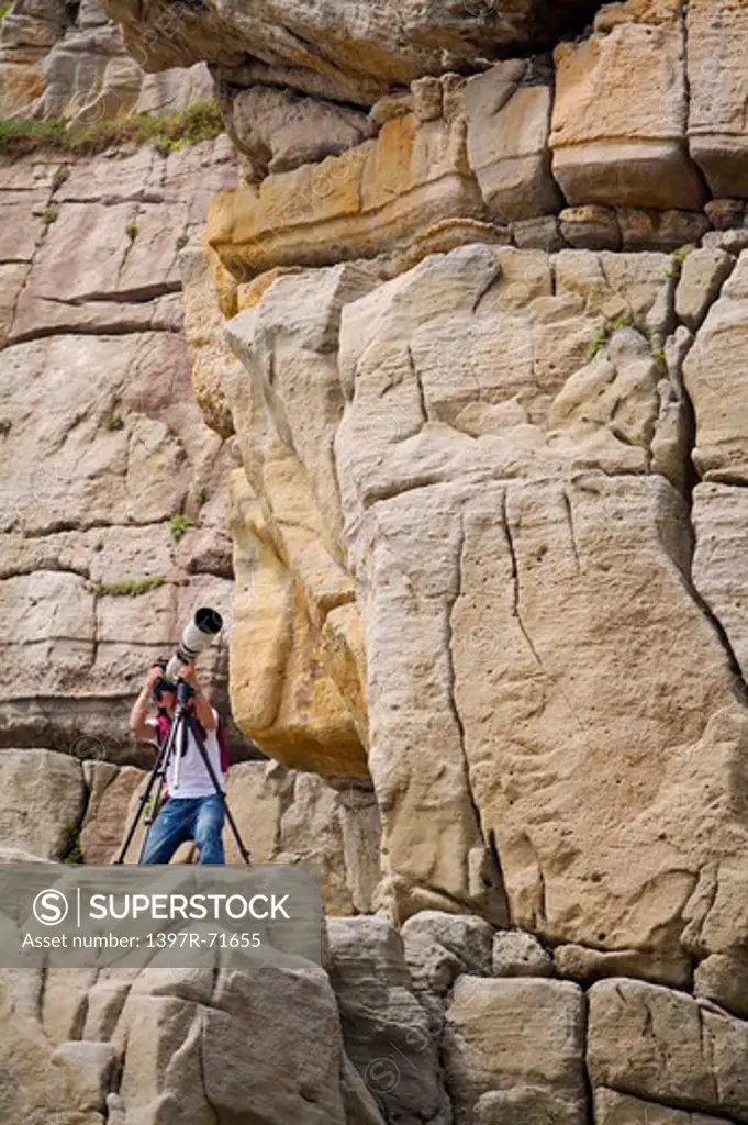 Mature man taking pictures on the cliff, Photographing, Recreation