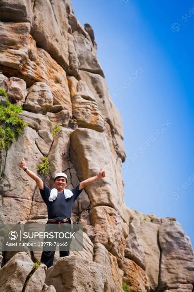 Mature man standing on the cliff, Rock Climbing, Extreme Sports