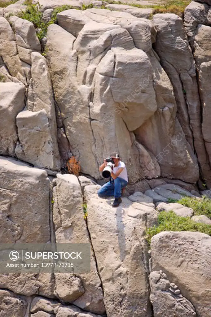 Photographer taking pictures on the cliff, Photographing, Leisure Activity