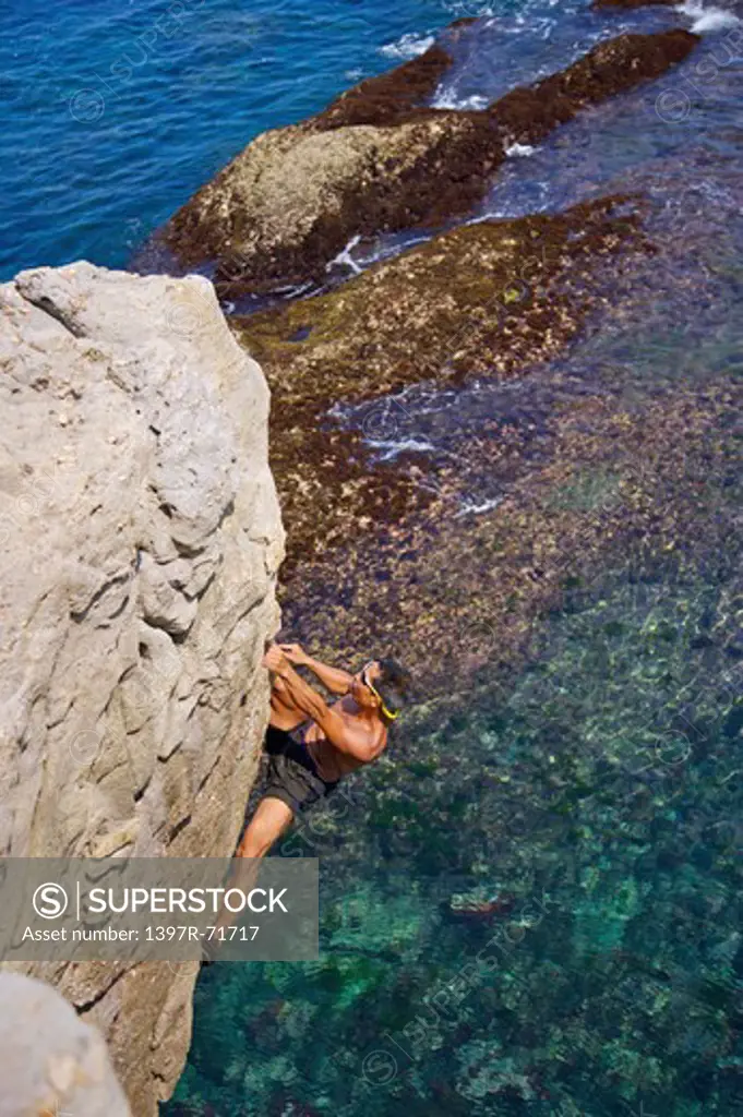 Mature man climbing on the cliff, Rock Climbing, Extreme Sports