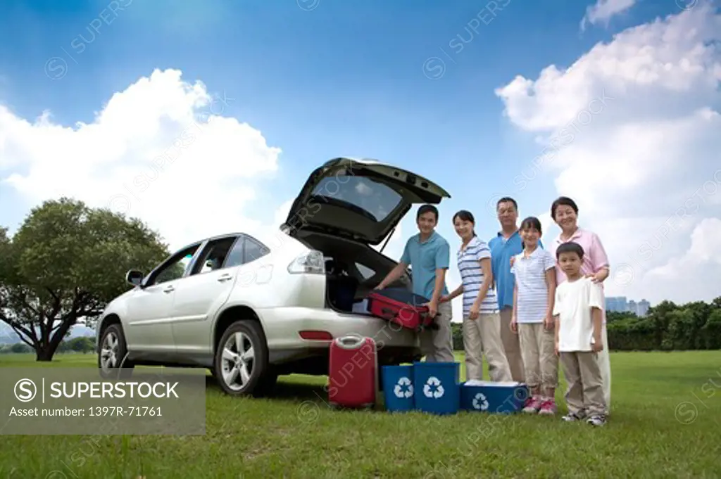 Multi-generational family outing with their car