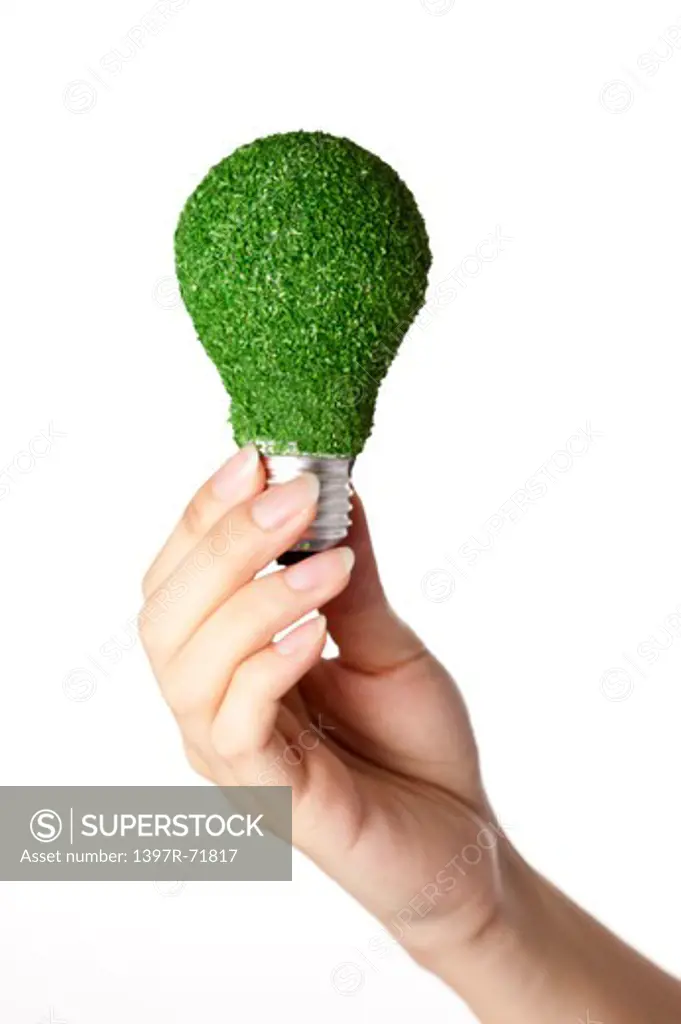 Woman holding a light bulb covered in moss