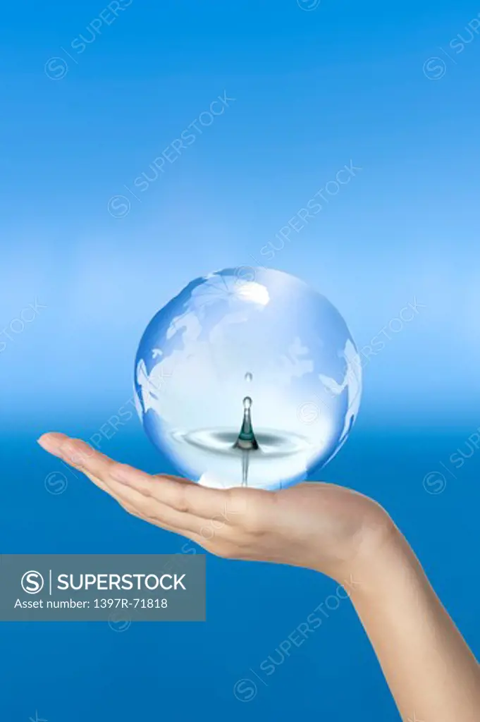 Woman holding a crystal ball with water drop and ripples in it