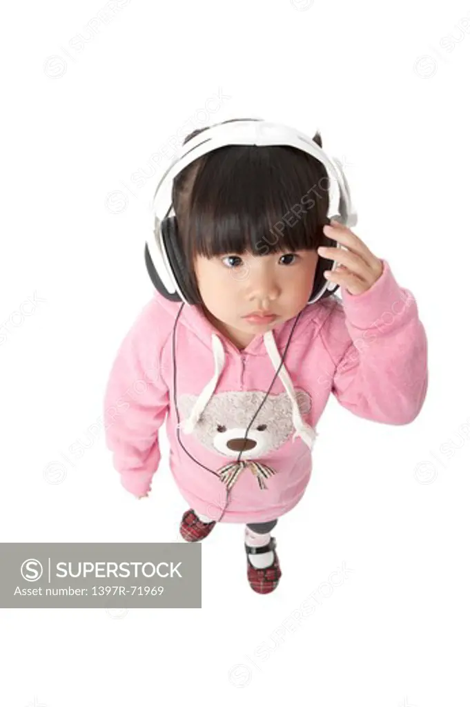 Little girl listening to music with headphones