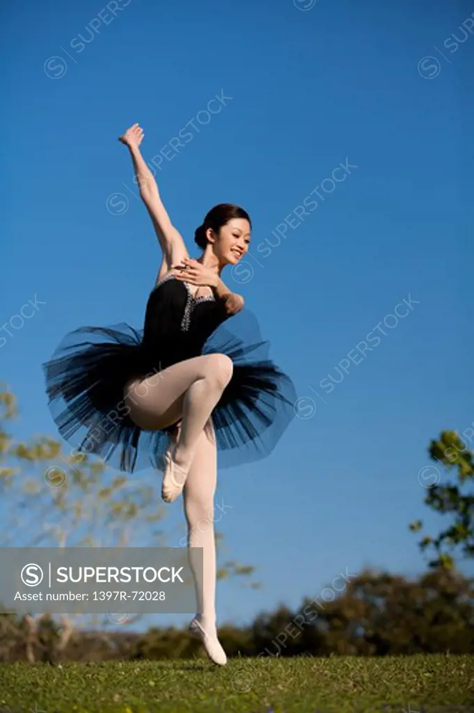 Ballet dancer dancing on the lawn