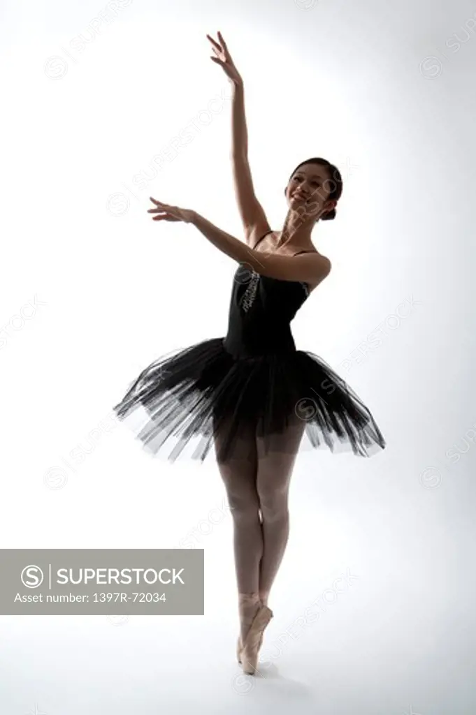 Ballet dancer dancing and looking up with smile