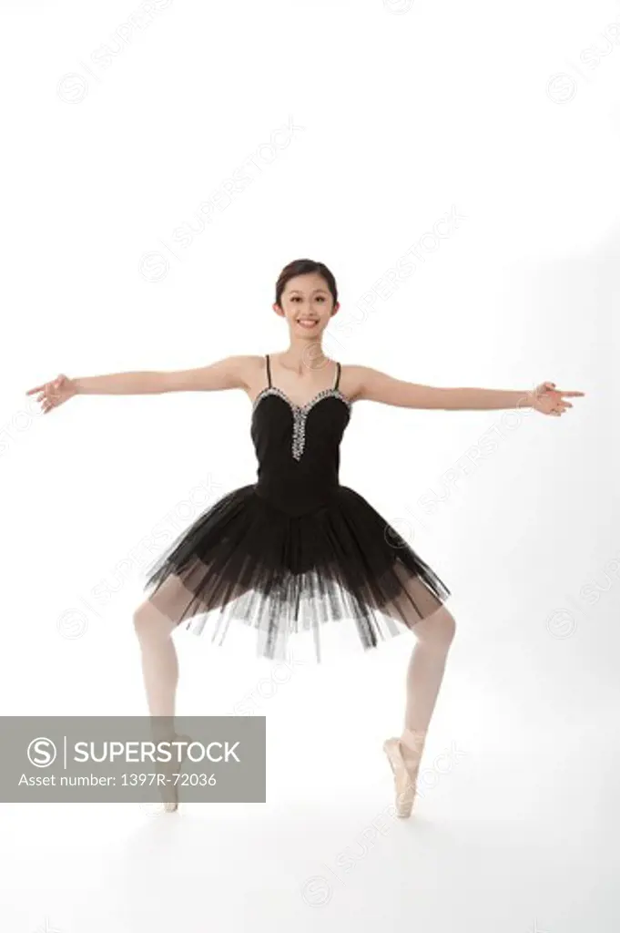 Ballet dancer dancing and smiling at the camera
