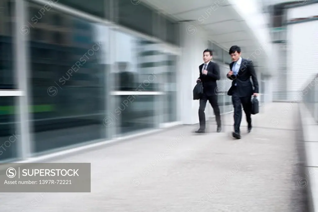 Businessmen in a rush, blurred motion