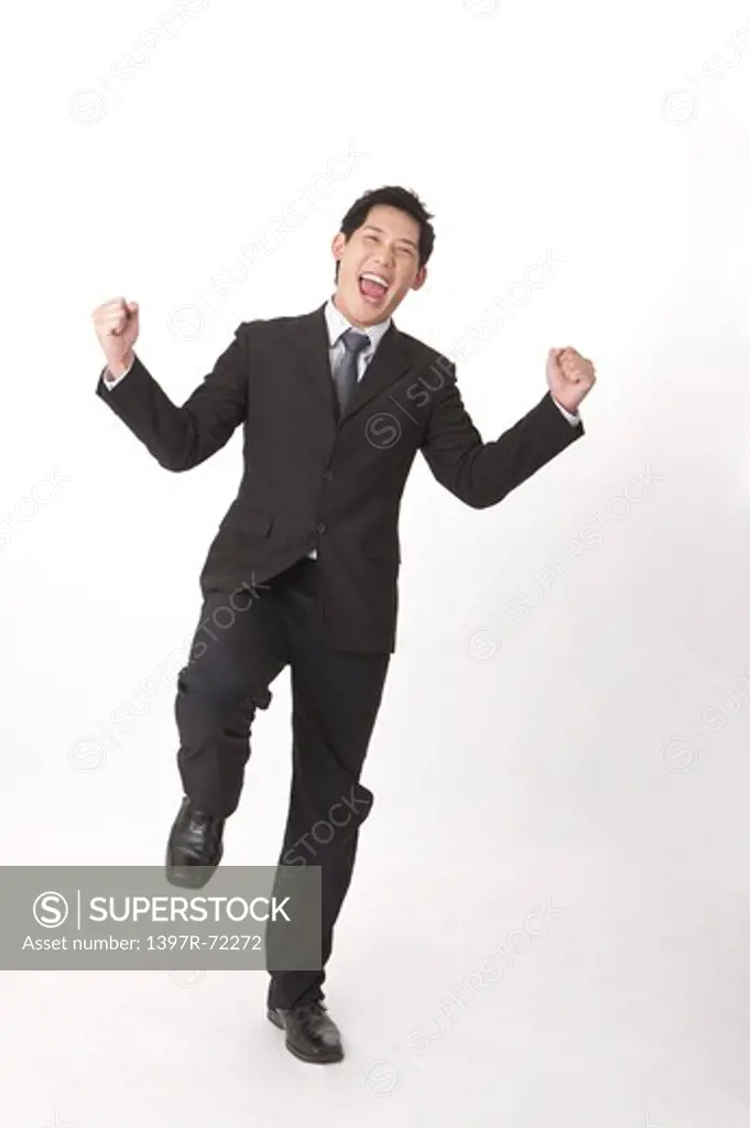 Businessman laughing with fists up