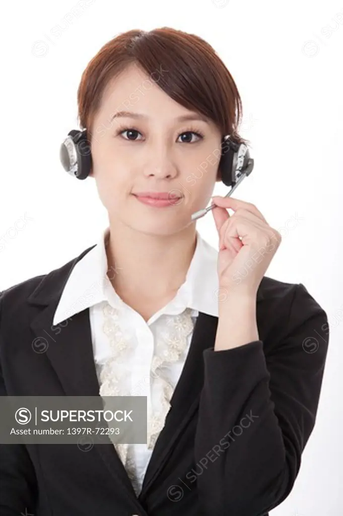 Businesswoman wearing headphone and looking at the camera with smile