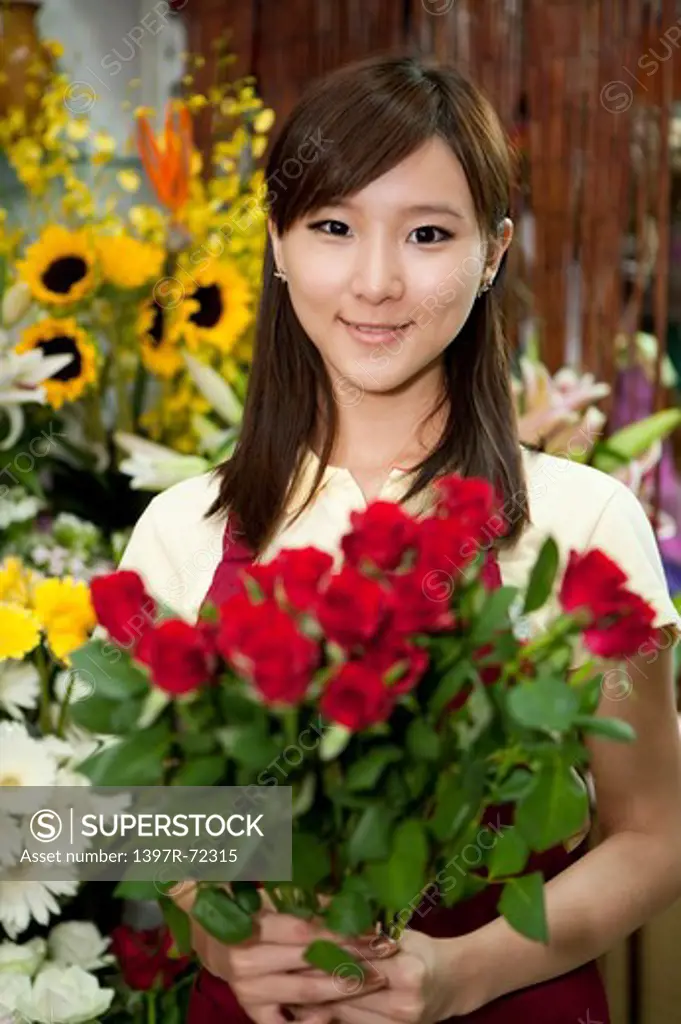 Female florist holding a bunch of rose