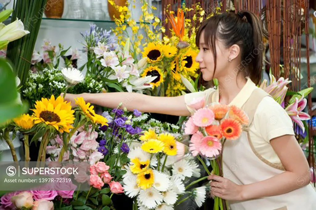 Female florist picking flowers to add into a bunch