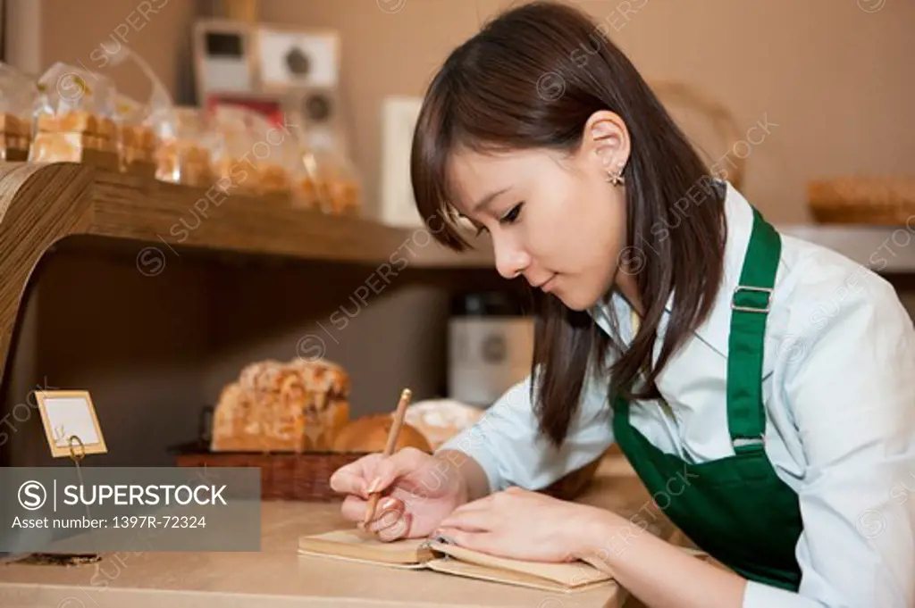 Female baker accounting