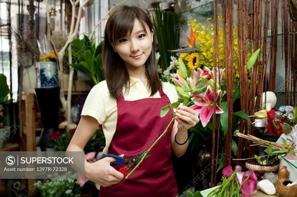 Female florist arranging flowers in the flower shop