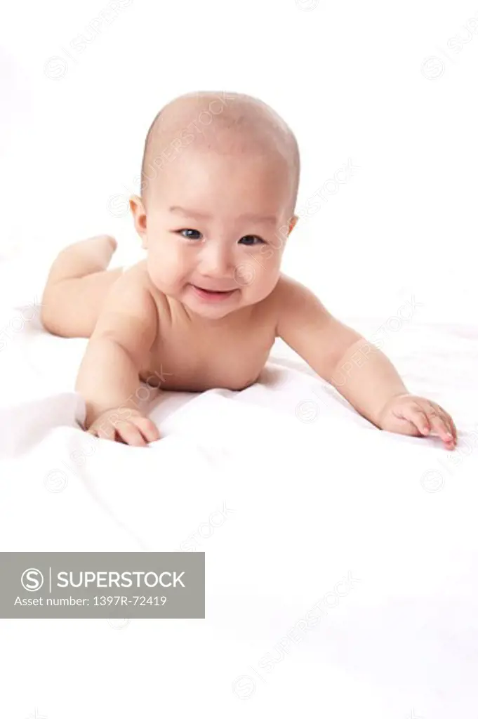 Baby boy lying on front with smile