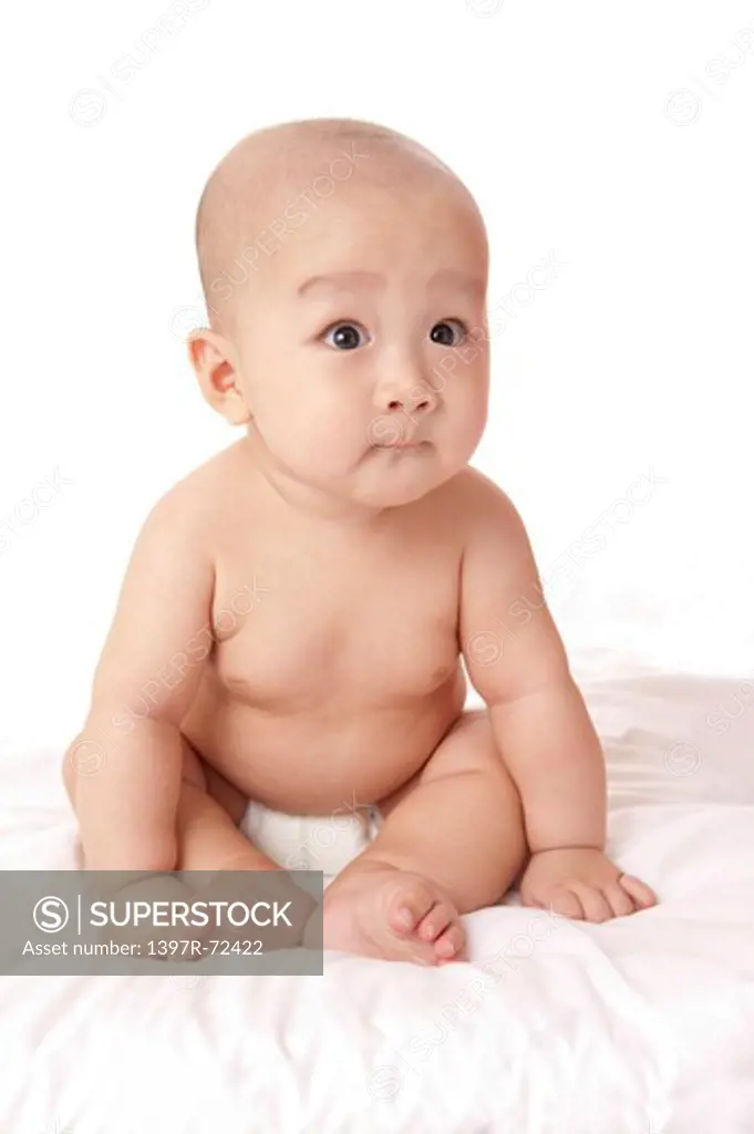 Baby boy looking away with shocking facial expression