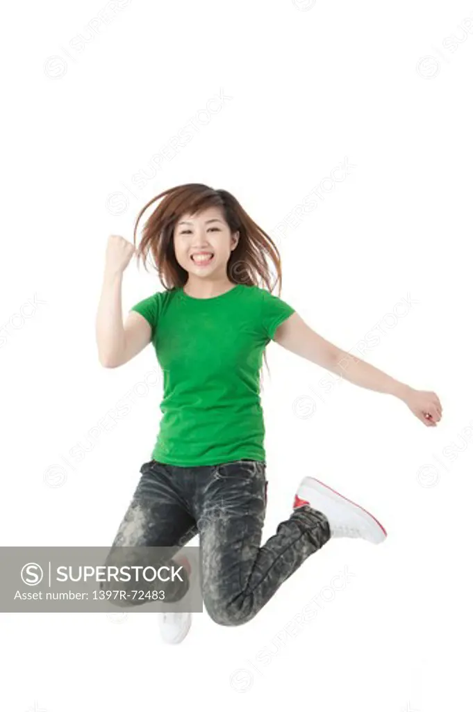 Young woman jumping in mid-air with smile