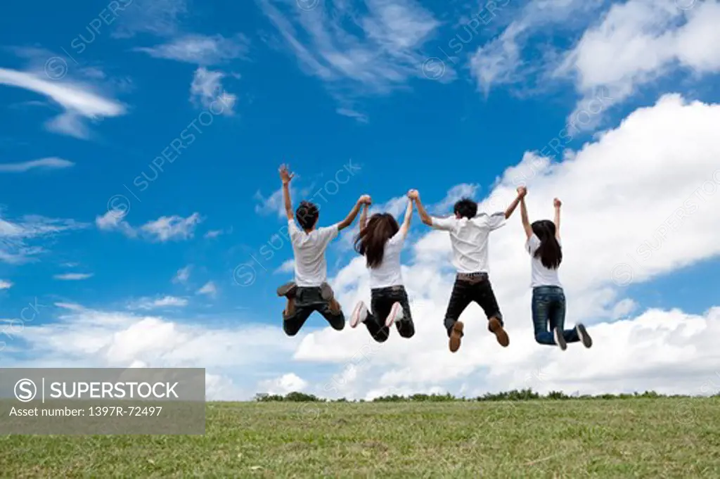 Young adults jumping in mid-air together