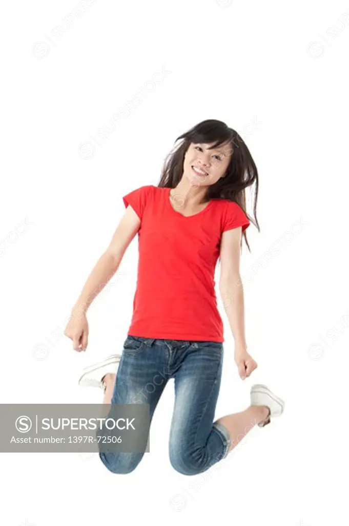 Young woman jumping in mid-air with smile