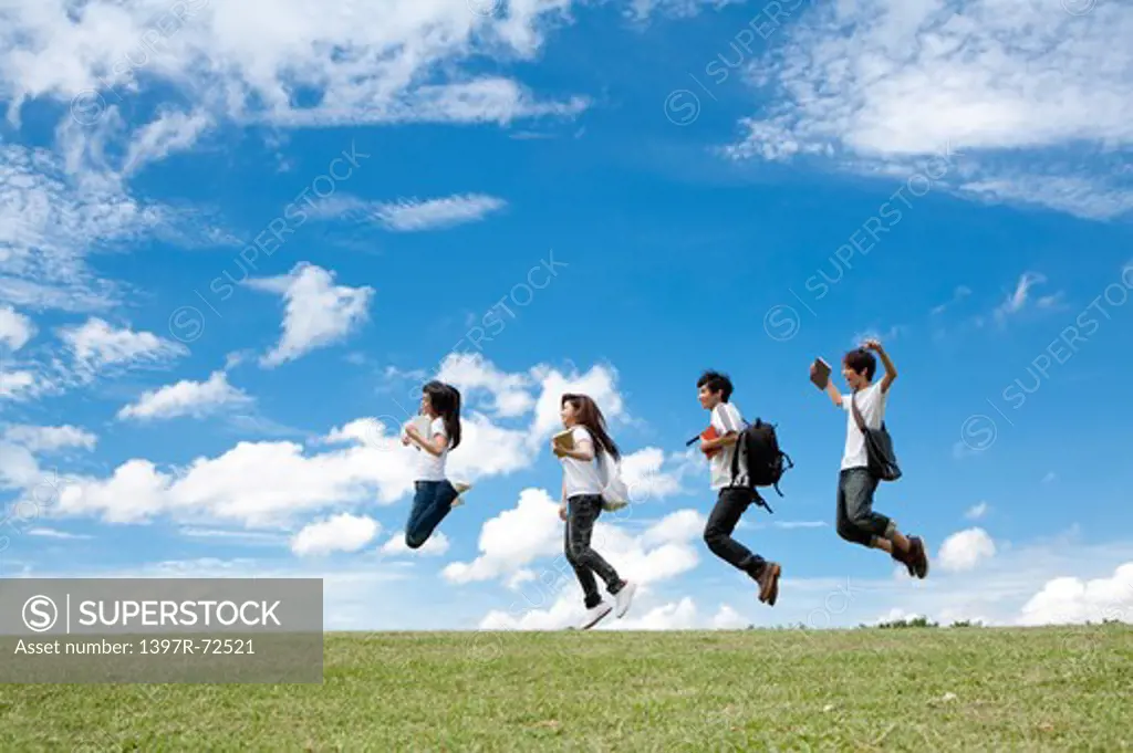 Young adults jumping in mid-air together