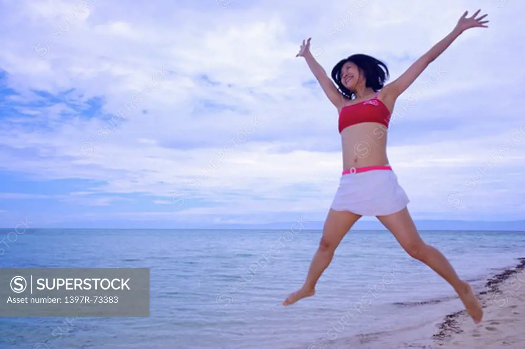 Balicasag Island, Cebu, Philippines, Asia, Woman jumping in mid-air with smile