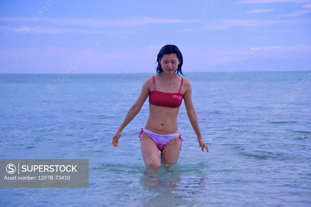Balicasag Island, Cebu, Philippines, Asia, Woman walking in the sea and looking down