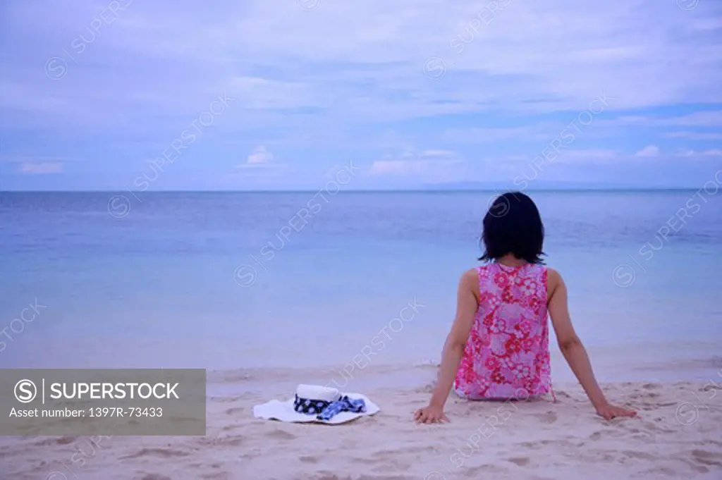 Balicasag Island, Cebu, Philippines, Asia, Woman sitting on beach and looking at sea