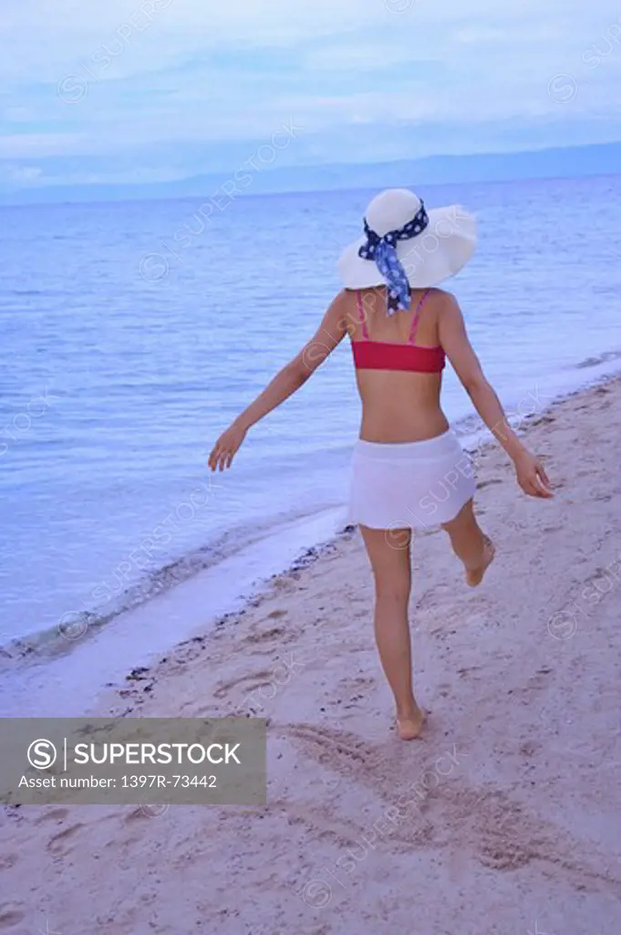 Balicasag Island, Cebu, Philippines, Asia, Woman walking on the beach with arms outstretched