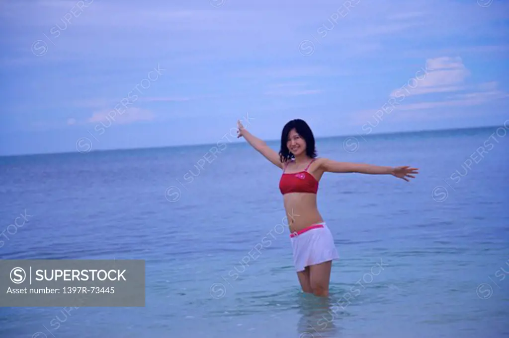 Balicasag Island, Cebu, Philippines, Asia, Woman standing in the water with arms outstretched