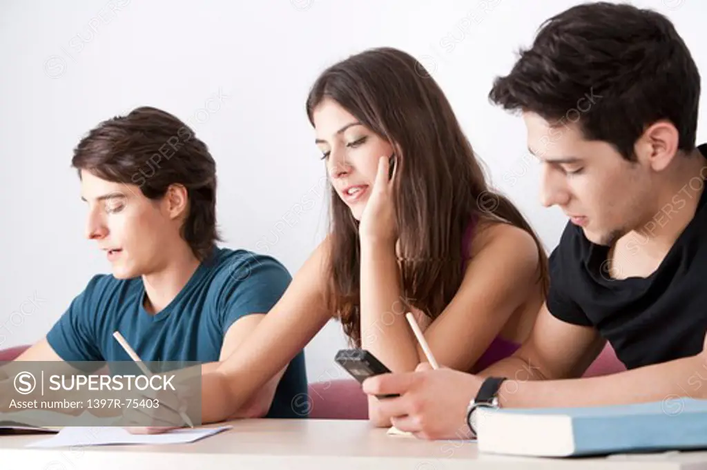 Students sitting in classroom, writing